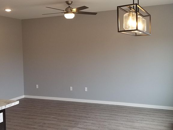 Modern farmhouse lighting in living room and dining room. Patio door is off of the dining room