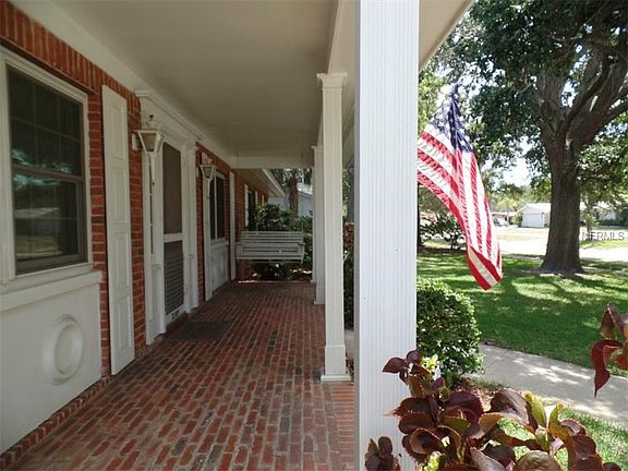 Relax and swing on your shady, brick front porch