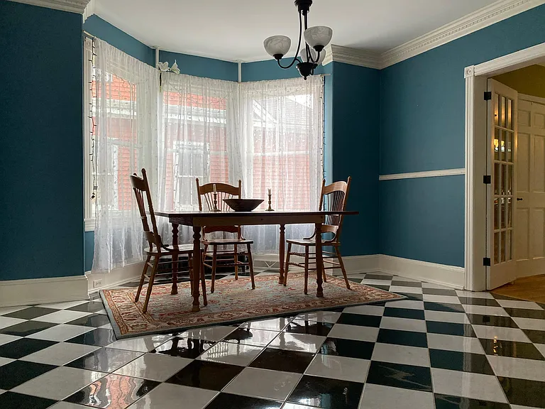 Dining room with bay window. This room may also be used as an additional first floor bedroom since there is an attached full bathroom.