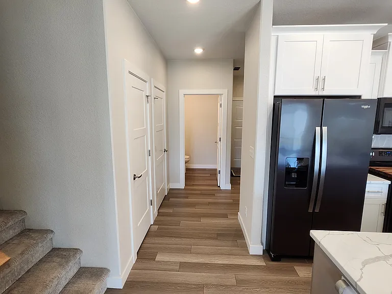 Looking toward the hallway leading to the half-bath, entrance to the garage, and also the main entrance. (Photo is of the unit.)