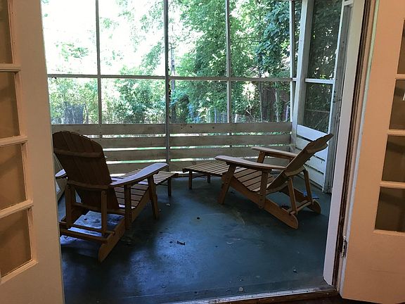 Screened porch overlooks back yard.