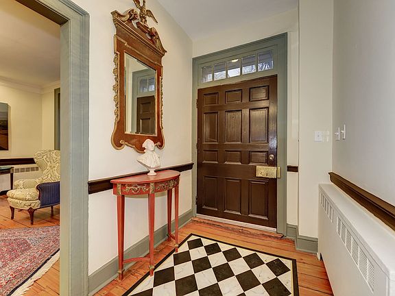 The oversized front door is topped by a multilight transom that brightens the foyer.