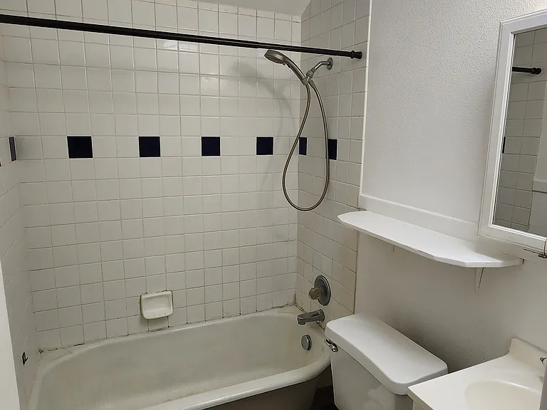 Bathroom with bathtub, toilet and sink cabinet