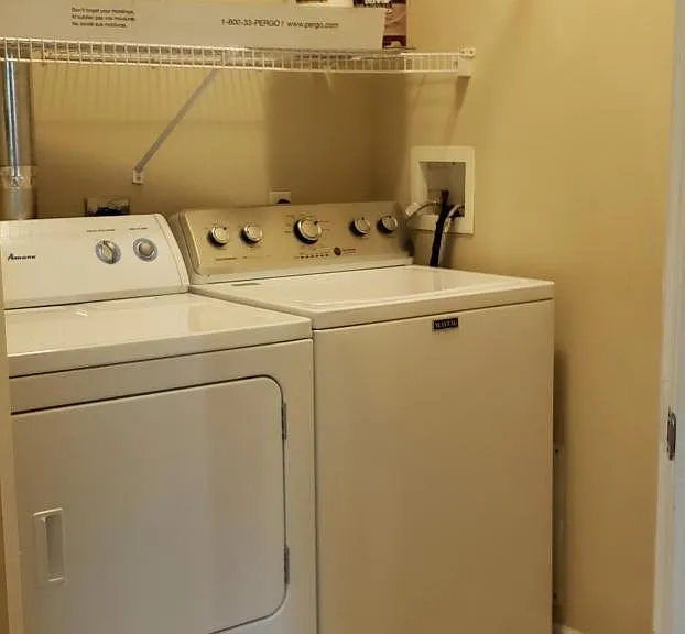 Ample room for laundry with shelving for supplies