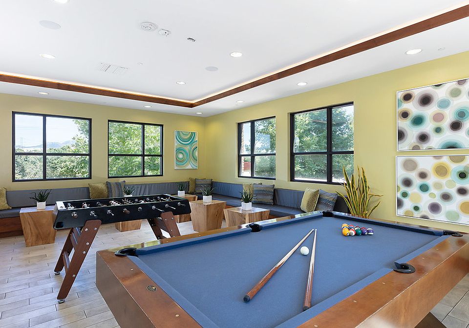 Recreation room with foosball table and pool table.