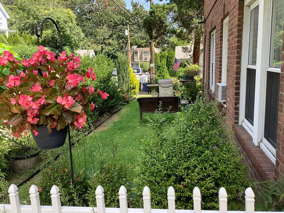 Front yard with quiet outdoor seating area.