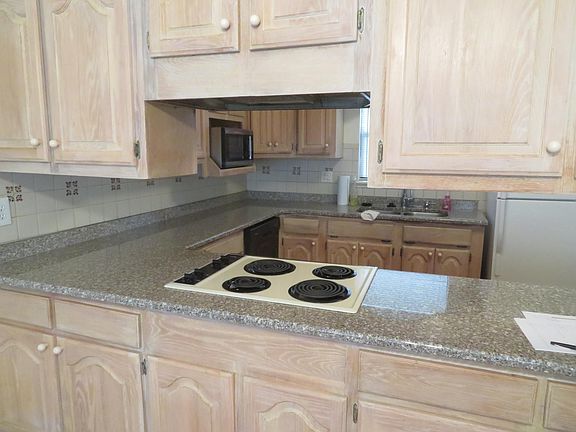 White washed cabinets that open from both sides with built-in lazy susans