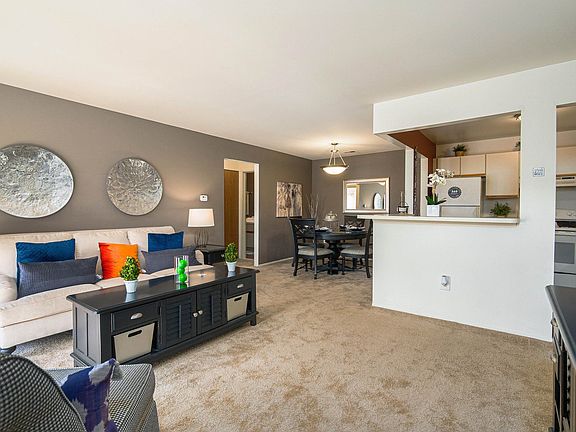 Open and airy living and dining room with all-natural light at Park Lane Apartments in Southfield, MI