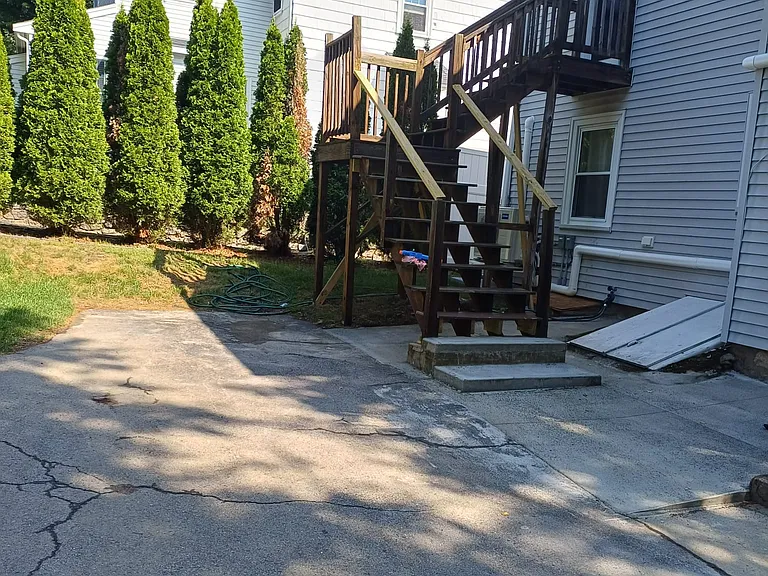 Deck stairs going up to bedroom facing backyard