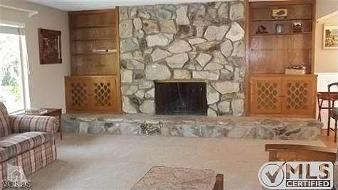 Living room of main portion of home. Newer carpet, lovely fireplace and gorgeous views from front wi