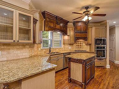 Luxury kitchen with solid wood cabinets, Electrolux appliances and granite countertops.