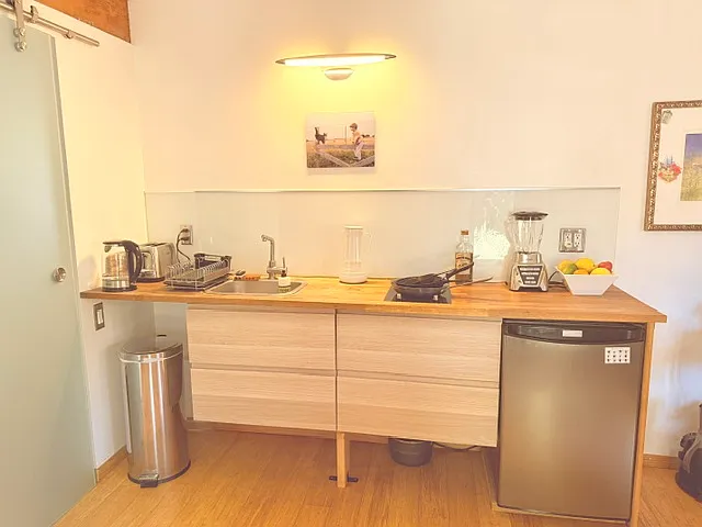 Kitchen with glass hot plates and all utensils and gadgets (Electric oven on work bench)