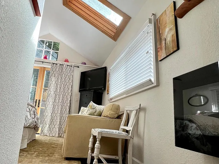 Hallway with hardwood floors.
Bedroom skylight.
