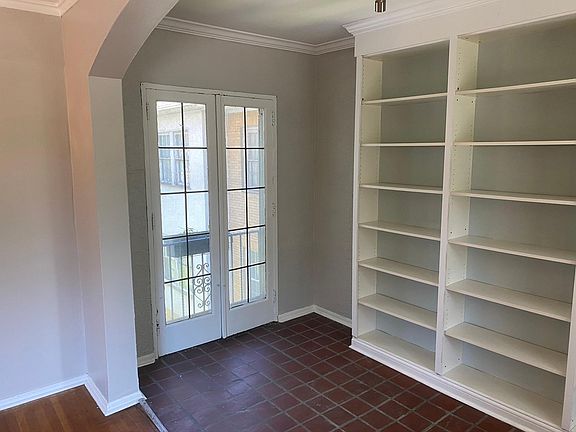 "Sunporch" off living room with wall of bookshelves.