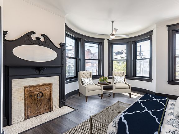 Stunning primary suite with another original fireplace. This room could also be a beautiful living or dining room.