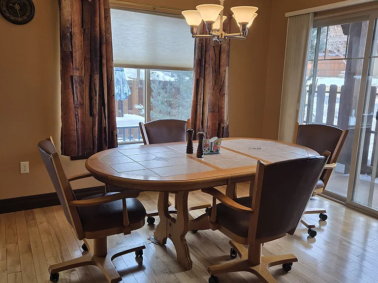 Dining room, which opens up to the living room and kitchen. Sliding glass door opens to private back patio and gas BBQ grill