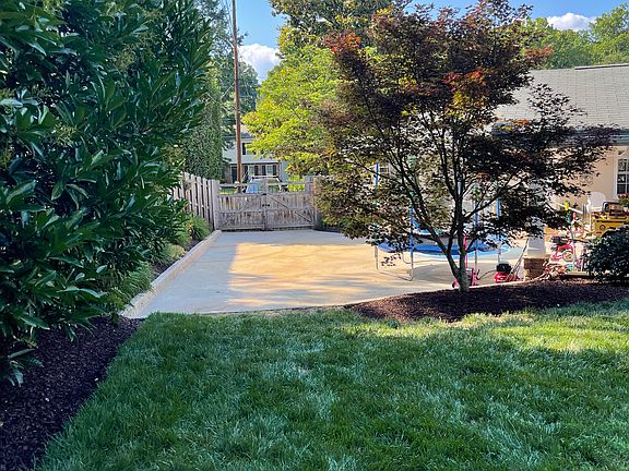 View of driveway and gate from the backyard