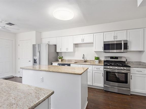 The light and bright kitchen provides plenty of space for food prep and entertaining guests.