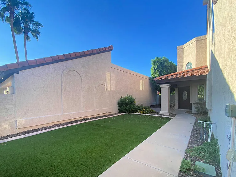 Fully enclosed courtyard patio with turf