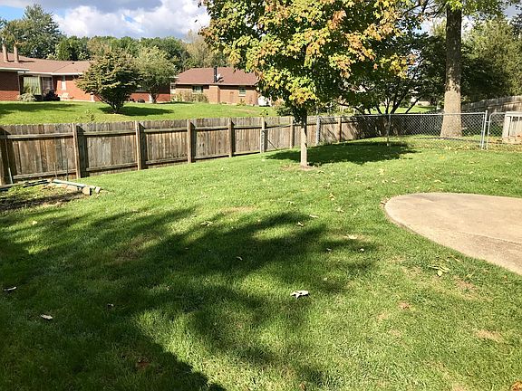 Fenced backyard with garden plot