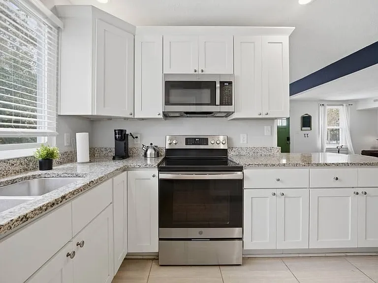 Full kitchen setup with updated appliances.