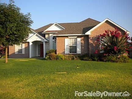 Home Front
						:
						Professionally cared for lawn with brick exterior and covered entry.