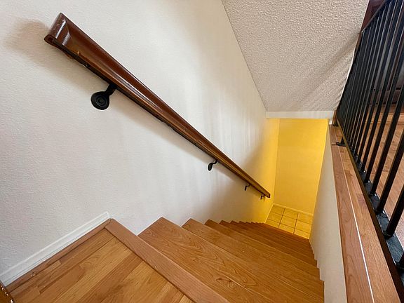 Stairs from garage into first floor- living room, half bath, patio, kitchen.