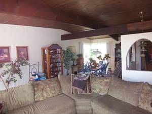 Spacious living room with wood beamed ceiling. 