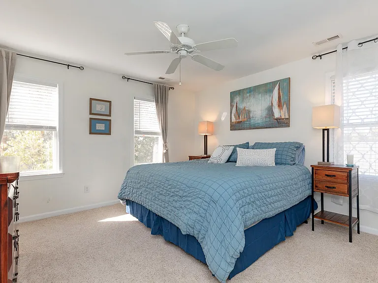 Spacious master bedroom includes carpet, spacious walk-in closet, ensuite bathroom, ceiling fan, and lots of windows letting in natural light.