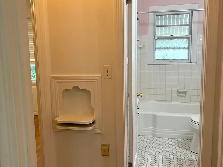 Small hallway leading to bathroom.