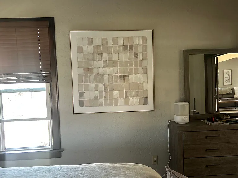 Textured decor on bedroom wall.