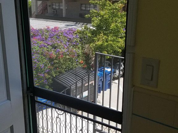 BACK DOOR W/ STAIRWAY TO PARKING LOT