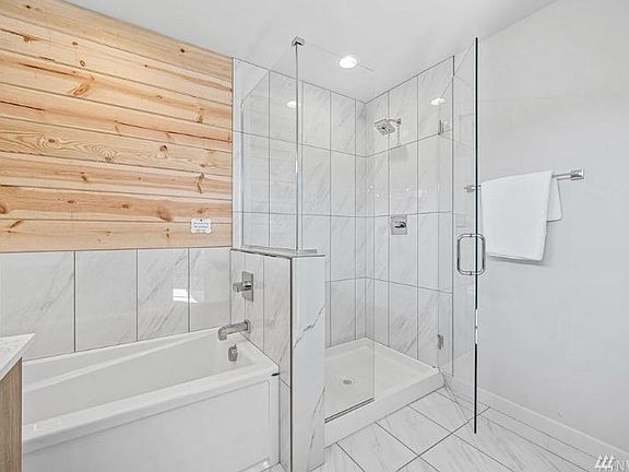 Master bath with standing shower and bath tub.