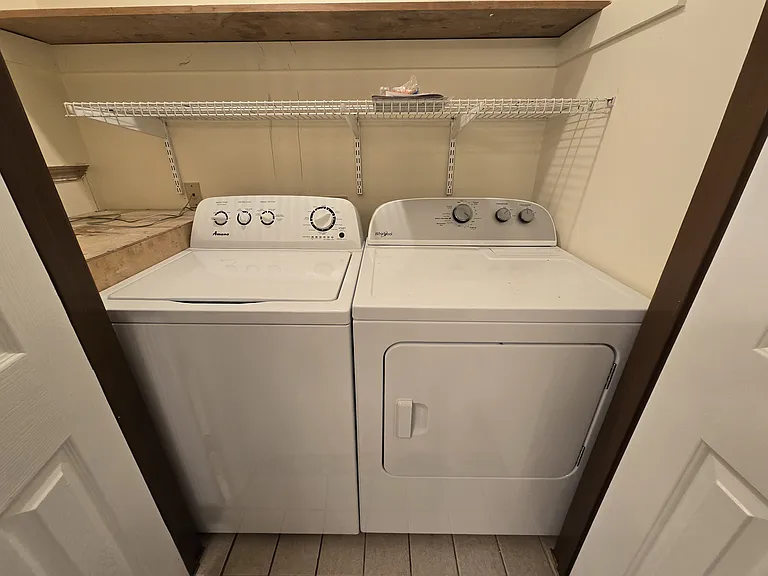 New washer and dryer in closet in bathroom