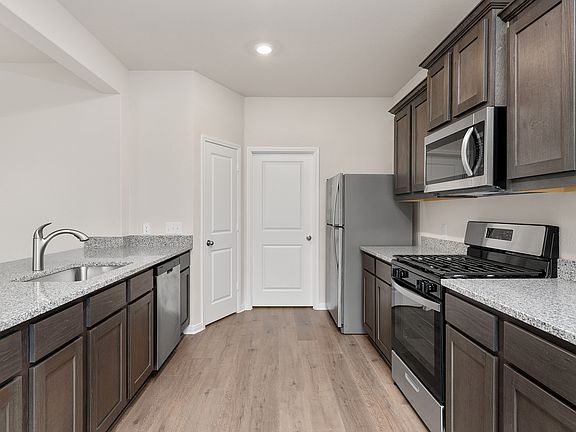 The kitchen of the Cypress has gorgeous wood cabinetry.