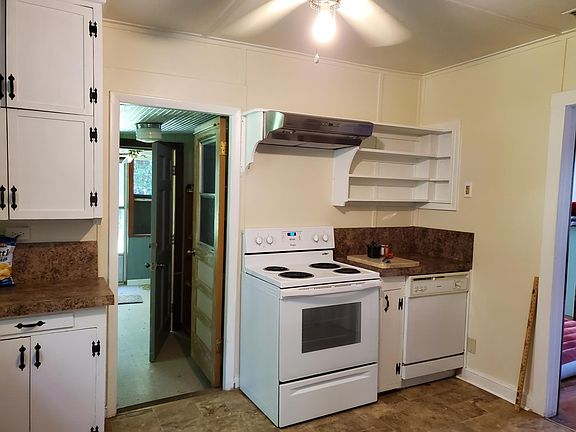kitchen looking into laundry room, then screen porch.