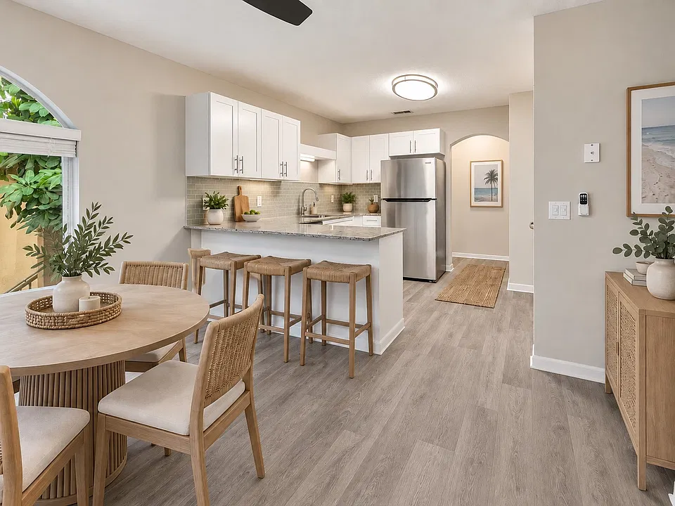 Elevate your lifestyle at Indian Hills with this modern kitchen featuring sleek appliances and stylish finishes. Ample space combined with a cozy dining area creates the perfect environment for entertaining. Explore your new home today!