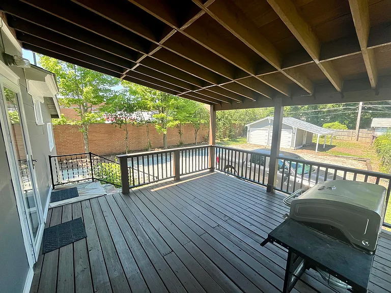back door, spacious deck, parking area, and garage