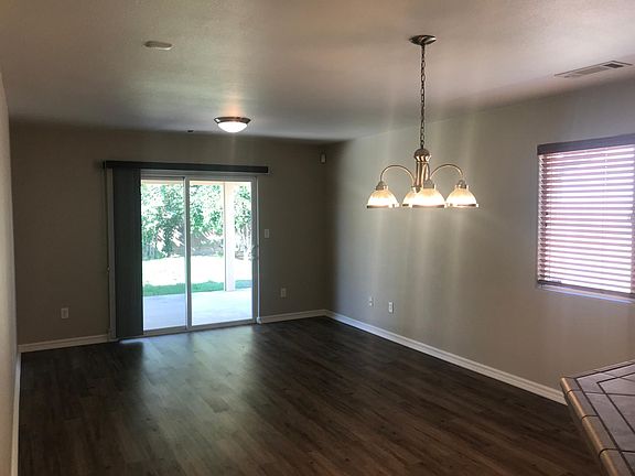 Family room opens onto large covered patio. Large backyard with fruit trees.