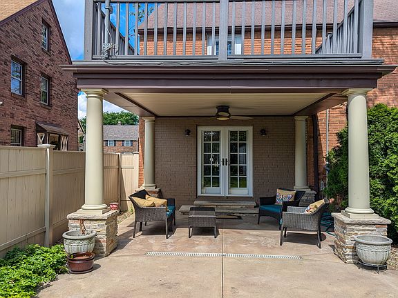 Back of house with downstairs patio