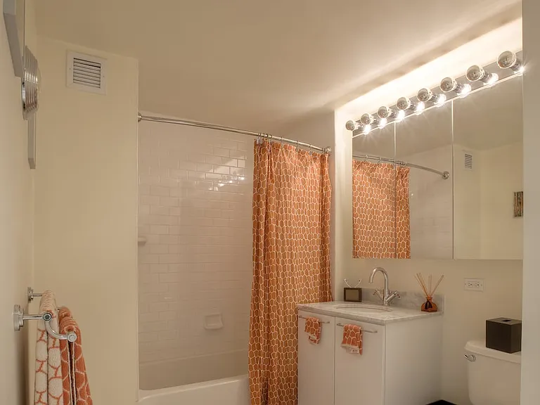 Classic Package I bath with white marbled granite countertops, white cabinetry, and hard surface flooring