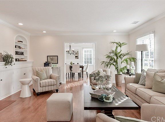 Large sunny Living room with original fireplace & built-ins.