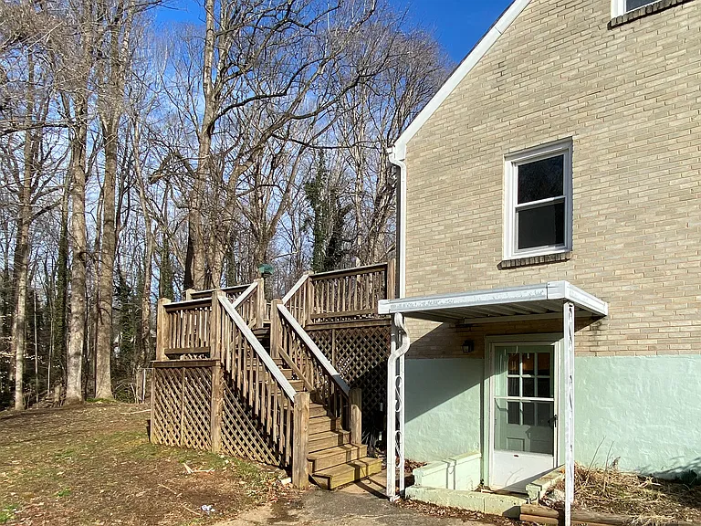 entrance to the unfinished basement with plenty of storage and washer/dryer