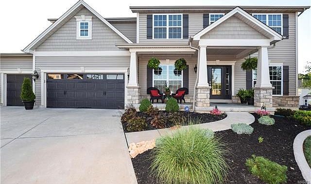 Welcome to 35 West Hampton Ridge Court.Love carriage style garage doors with windows!