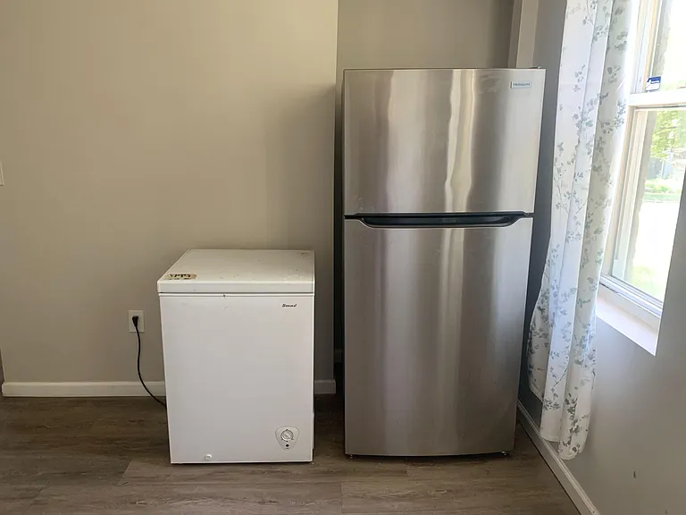 Kitchen includes a full-size refrigerator plus an additional freezer for extra food storage and meal prep.