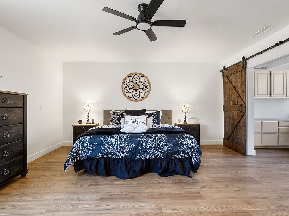 The main bedroom includes a spacious private workspace with a large desk and cabinets