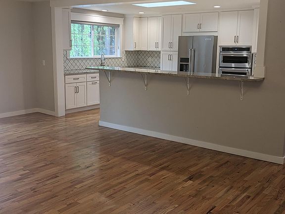 Bar separates kitchen from family room, while maintaining connection