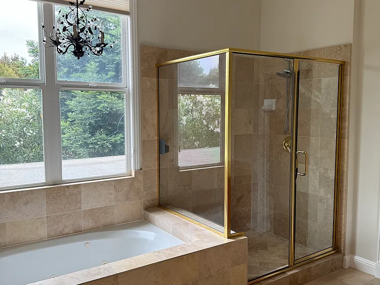 Primary bathroom with two walk-in closets, double sink, large soaking tub, and extra vanity area