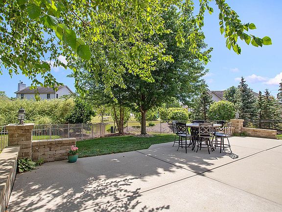 A wonderful, 36x26 concrete patio has it all:  Sitting wall, mature trees for shade.  BONUS:  The pa