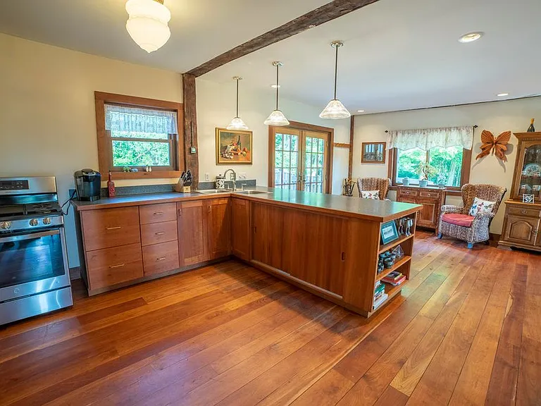 Kitchen with propane gas stove and refrigerator.